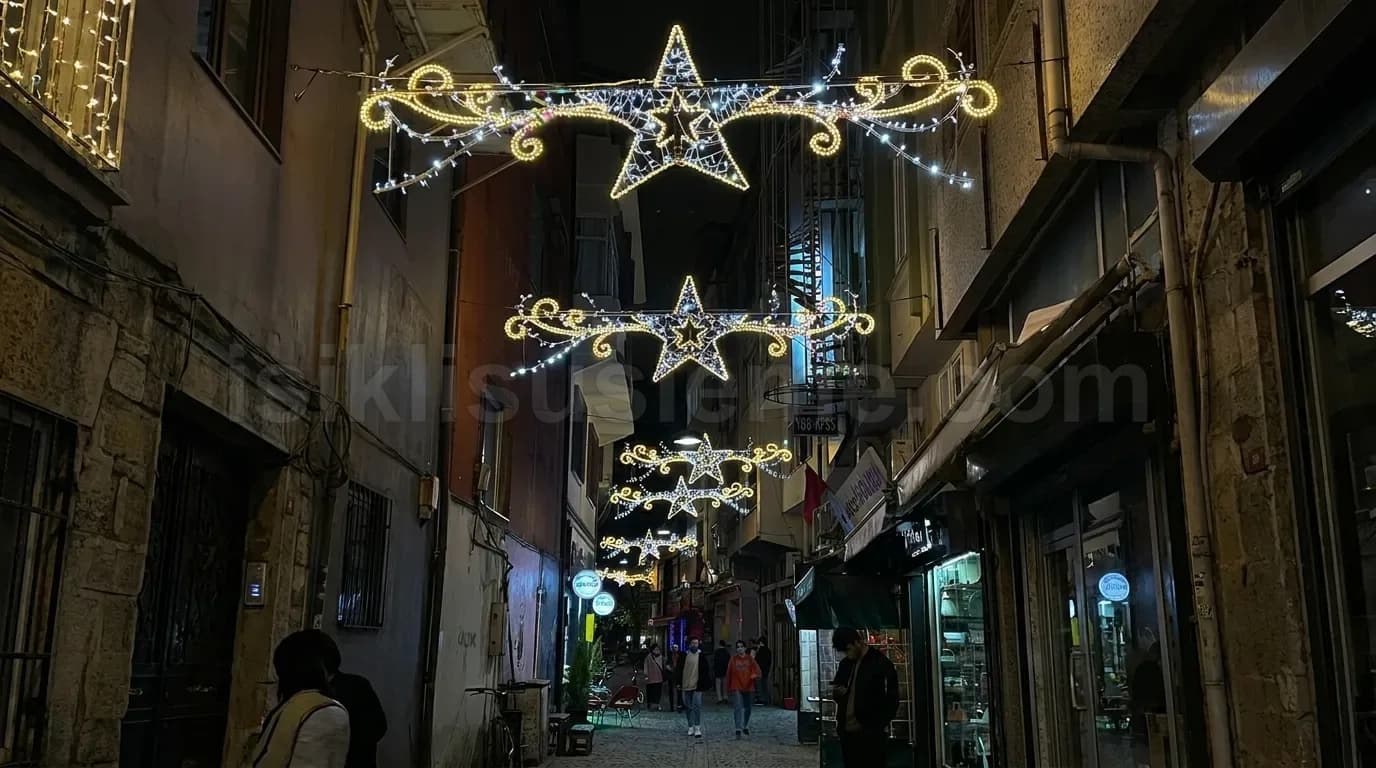 Tarihi dar sokak ustunde sicak beyaz LED yildiz ve motif susleme gece gorunumu