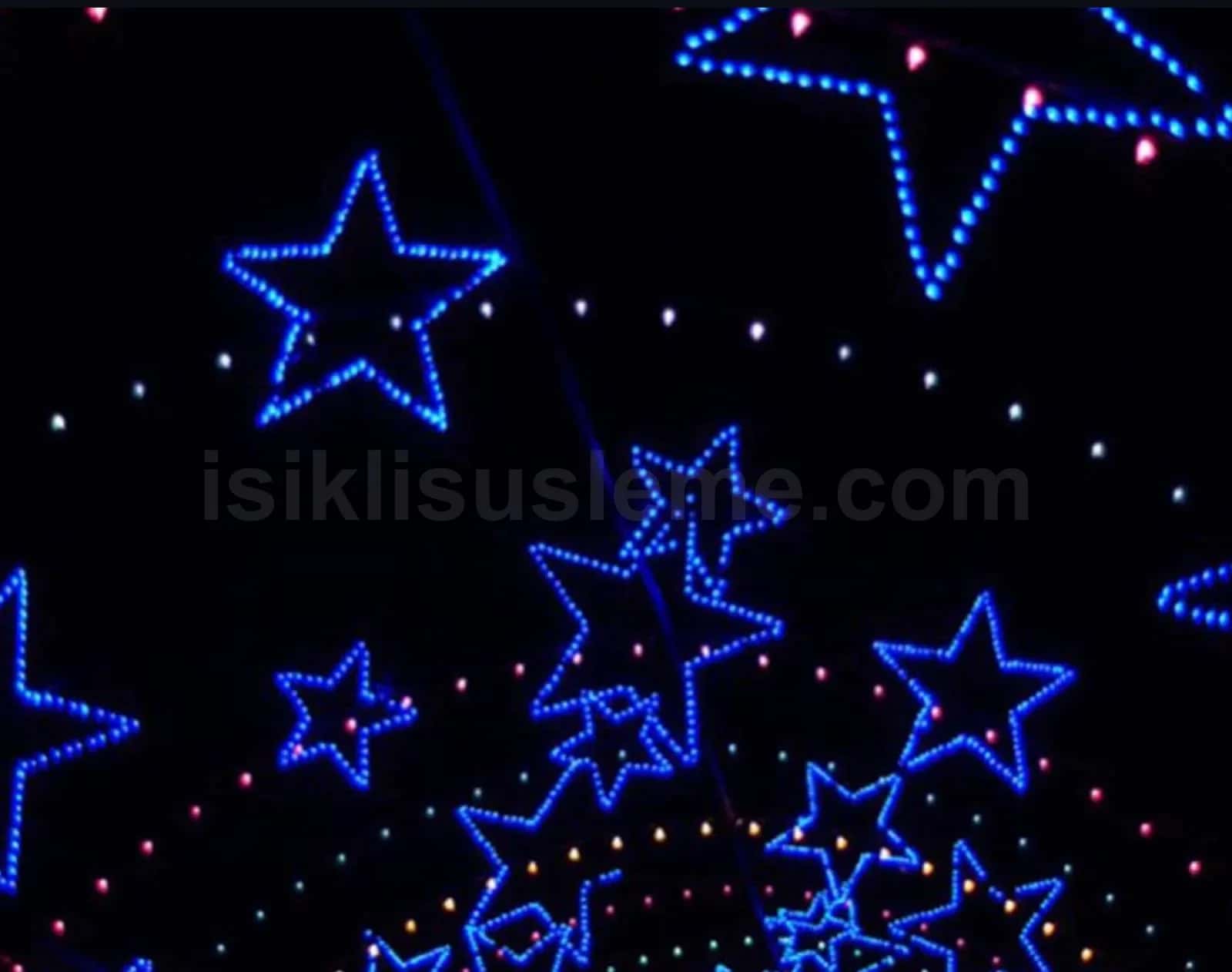Siyah fon uzerinde farkli boyutlarda mavi LED yildiz figur motifleri ve lazer isik efektleri